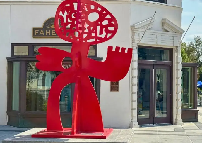 Victor Ekpuk Poses With His Sculpture "The Dance" on 14th and R St. DC. Photo by: Eugene O. Smith, Jr. 