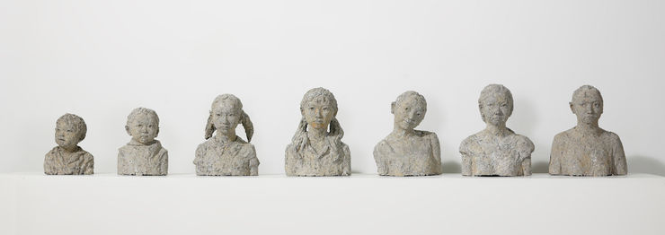 Seven papier mache bust sculptures that represent different ages of Artist Chen Qiulin from her childhood to adulthood.