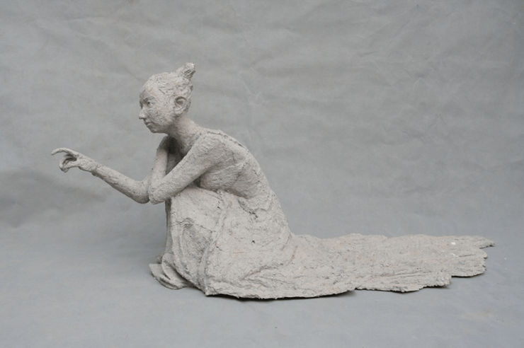 A girl scratches the wall.