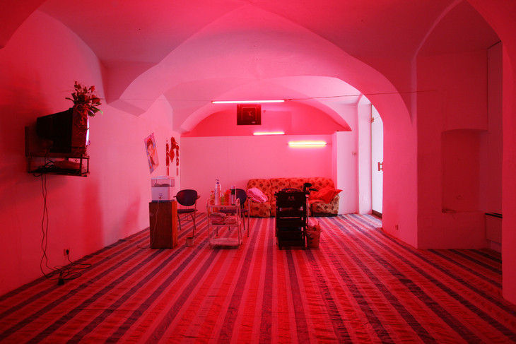 A barber shop is relocated into a room with pinkish neon lights in 2006