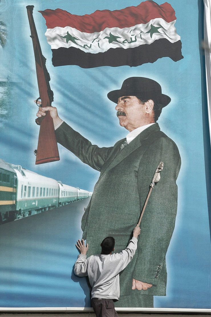 A worker cleans a giant poster of Iraqi leader Saddam Hussein in Bagdad, 2003 Archival Print On Cotton Paper Edition of 5 + 2 AP 100 x 70 cm