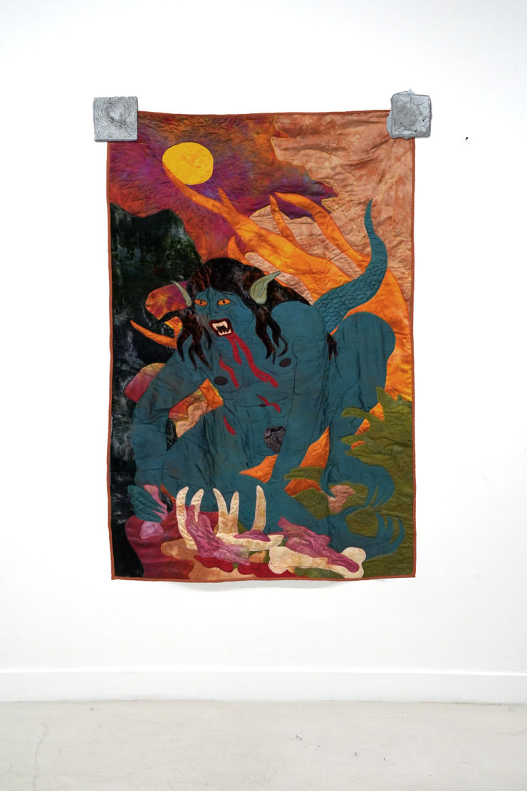 sewn tapestry hanging on wall