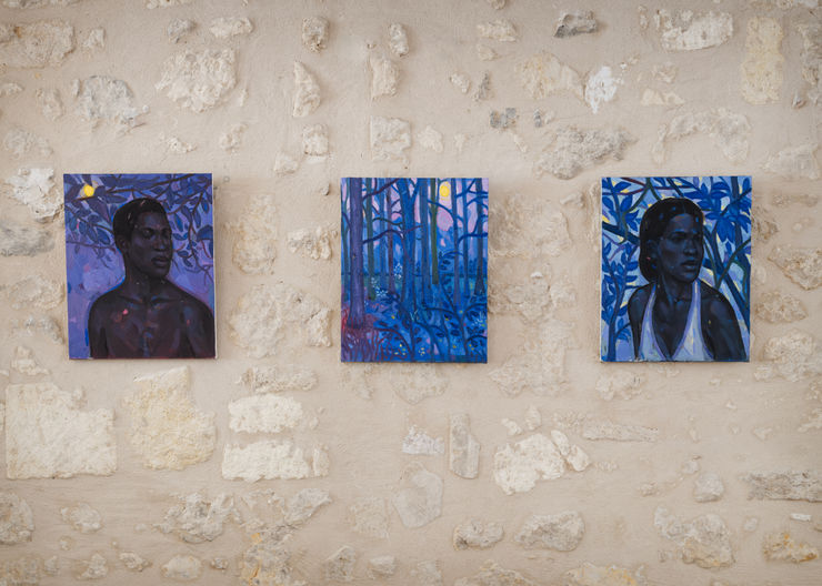 Installation view of three paintings by Stephen Price — Within the Blue Forest, The Blue Trees, and The Hidden Light — shown on a stone wall