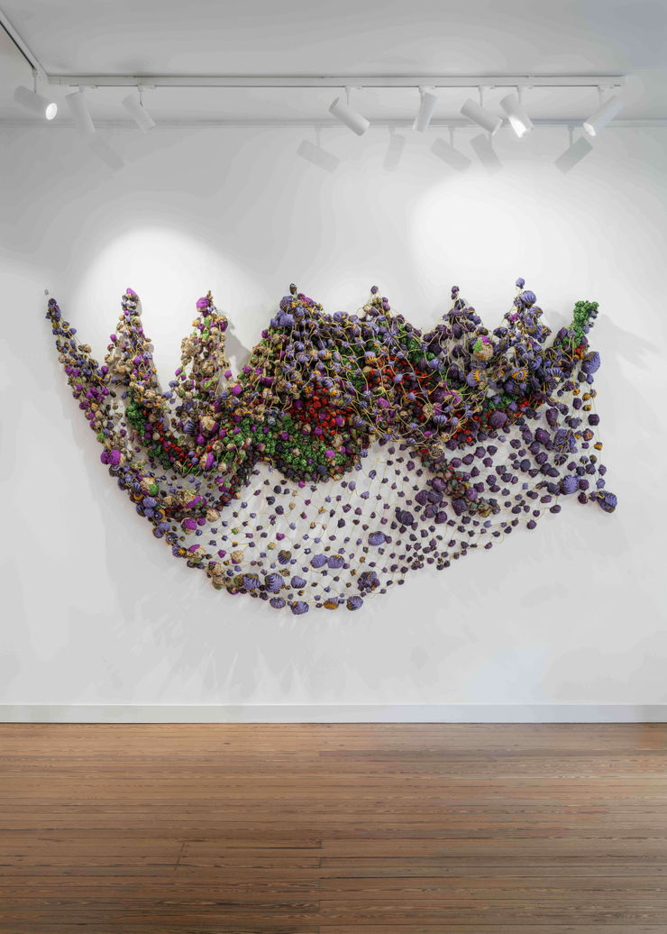 Large-scale textile installation by Nigerian artist Samuel Nnorom, featuring vibrant colors and intricate woven textures, exhibited at Galerie REVEL