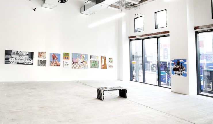 photograph of the gallery with paintings on the walls