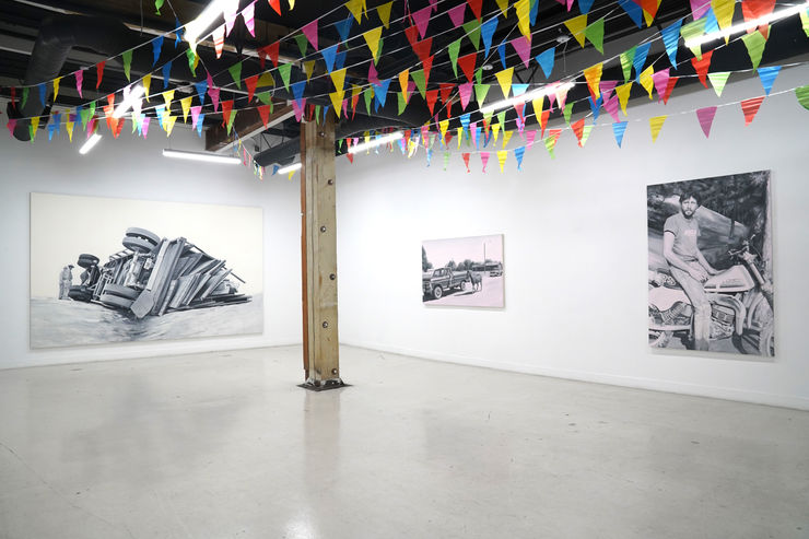 photograph of the gallery with paintings on the walls