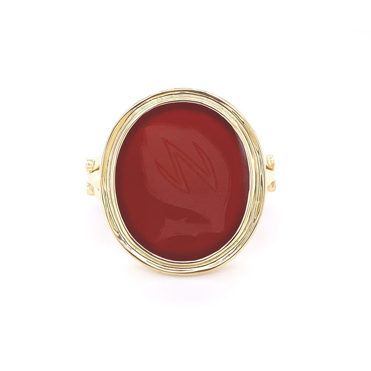Bespoke gold & carnelian signet ring with emblem intaglio. On white background
