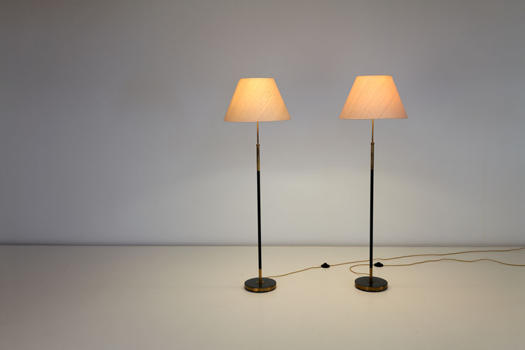 A pair of Einar Backstrom floor Lamps, 1950s. Made in Brass, lacquered steel, silk shades. pictured on with soft warm light.