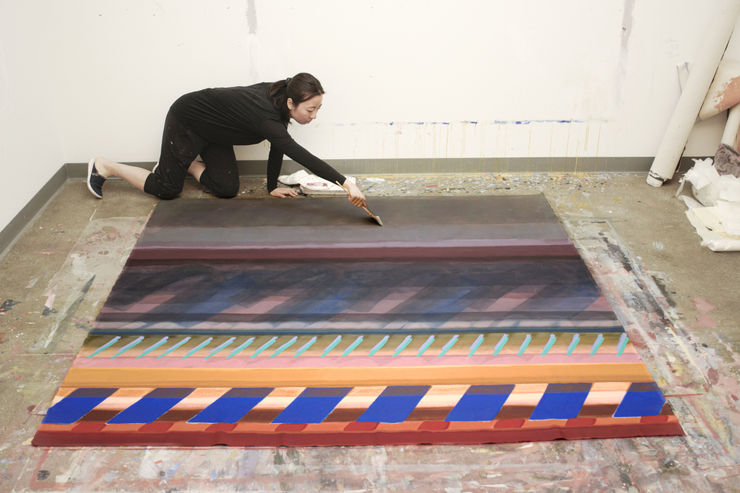 "Assisi no. 17" (painting by Adrienne Lee): the artist makes a finishing touch on the work.