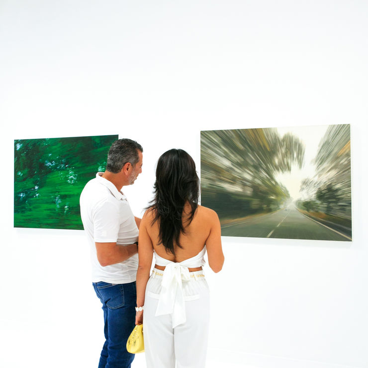 Gregory Thielker When Light Breaks exhibition installation view with guests in front of paintings at Square One Gallery
