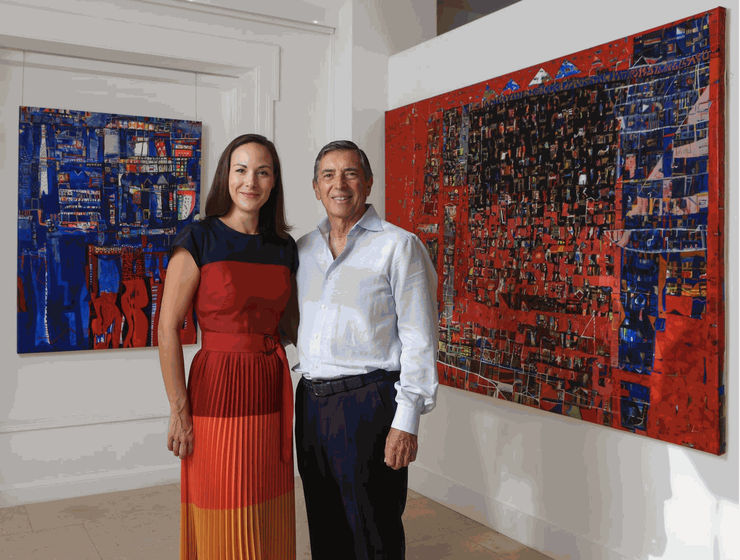 Owners Carla Berenice & Joseph Knapek in front of works by Esteban Leyva