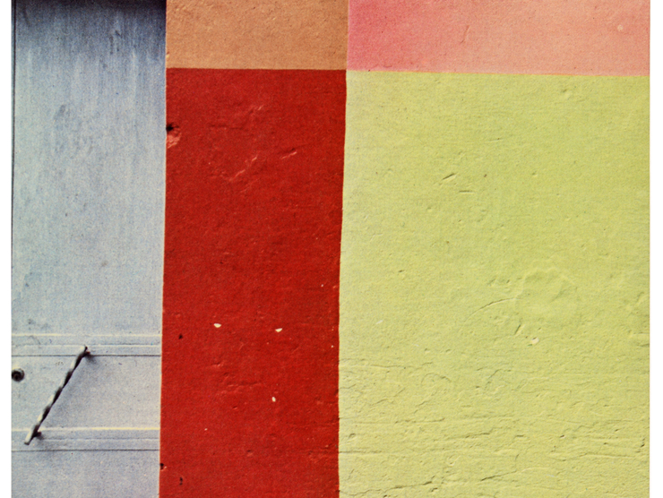 An abstract color photograph shows color blocks painted on a wall outside.