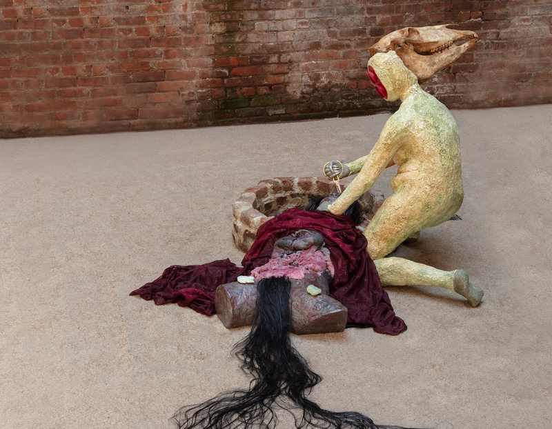 A sculpture by Cato Ouyang of two figures at a well.