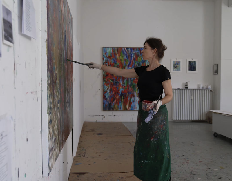 Artist Sabine Moritz painting in her studio