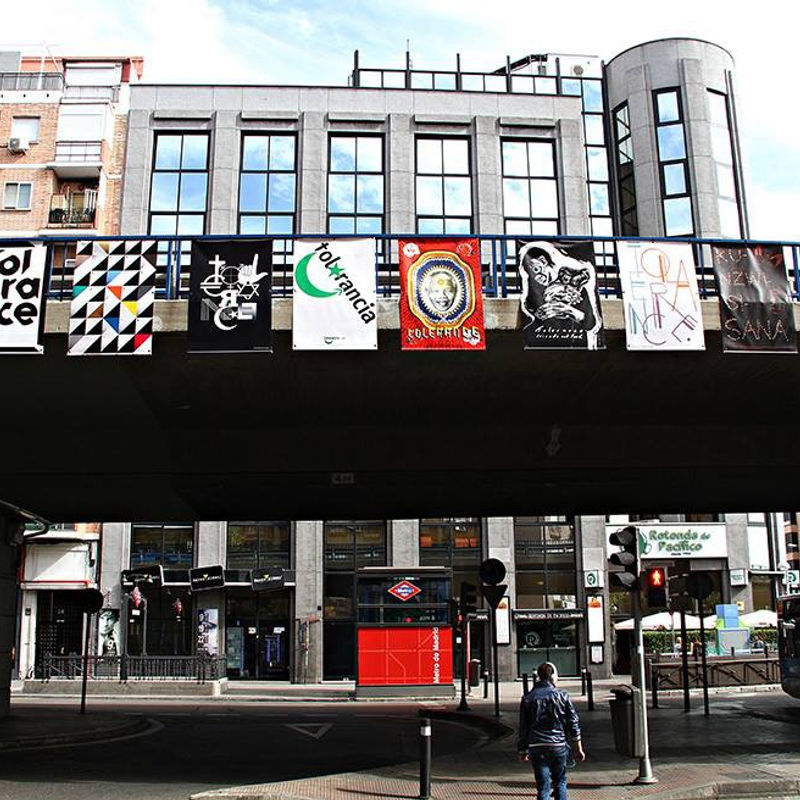 Outside exhibition installation of posters, including the artist's work "Friends Not Food," at the Tolerance Poster Show in Madrid