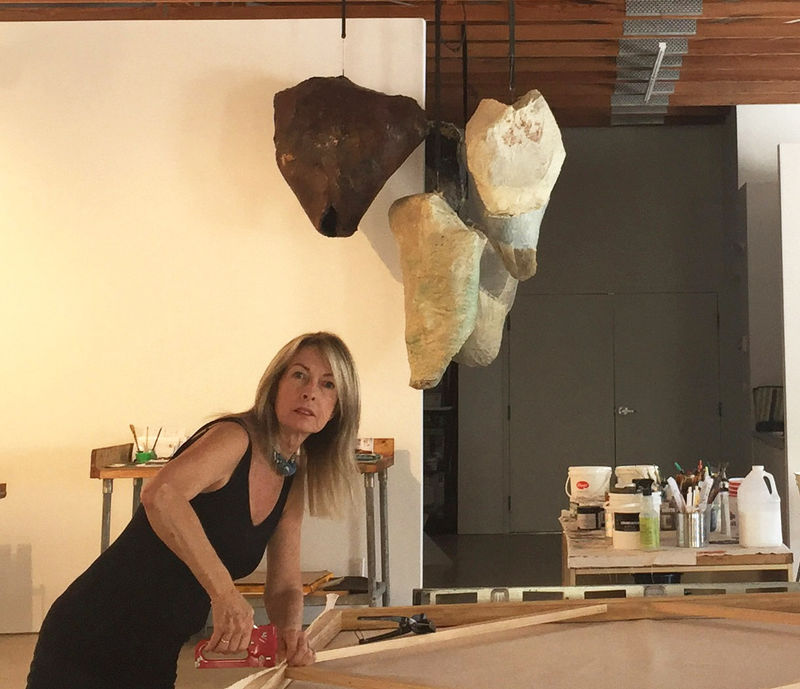 Artist Madeline Denaro preparing canvases in the studio.