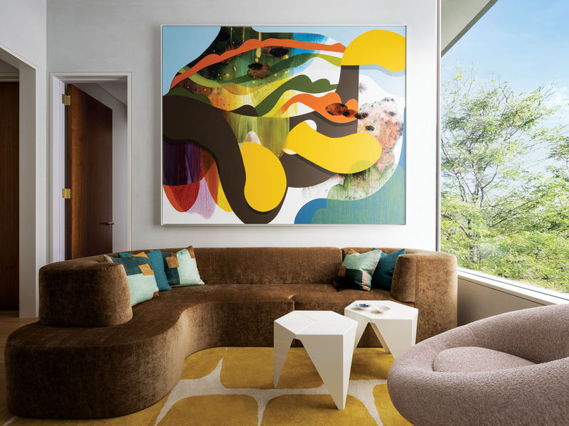 In the children’s sitting room, an artwork by Carrie Moyer overlooks a sofa designed by Lucien Rees Roberts, a pair of Isamu Noguchi tables, and a swivel lounge chair by Ben Swildens for Stabin Bennis; the rug is by Crosby Street Studios. PHOTO: ERIC PETSCHEK
