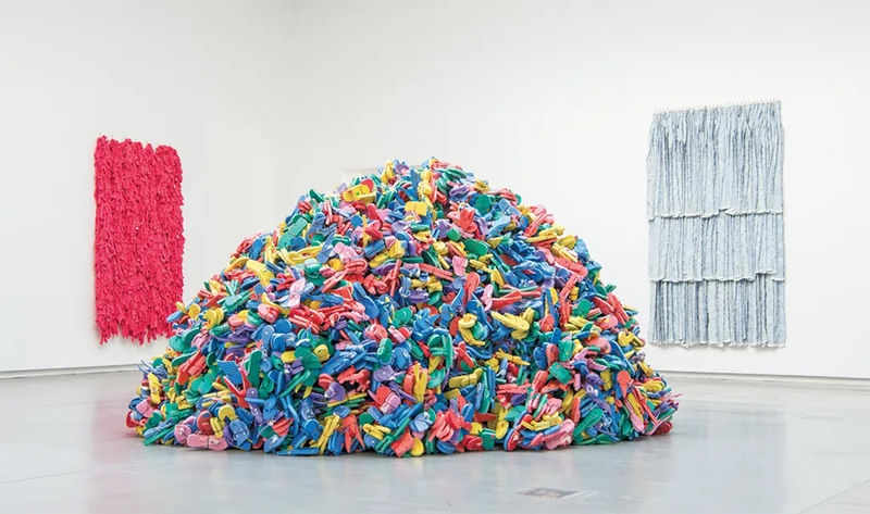 View of “Hassan Sharif,” 2017–18. From left: "Towel 3," 2013; "Slippers and Wire," 2009; "Rug 6," 2014.