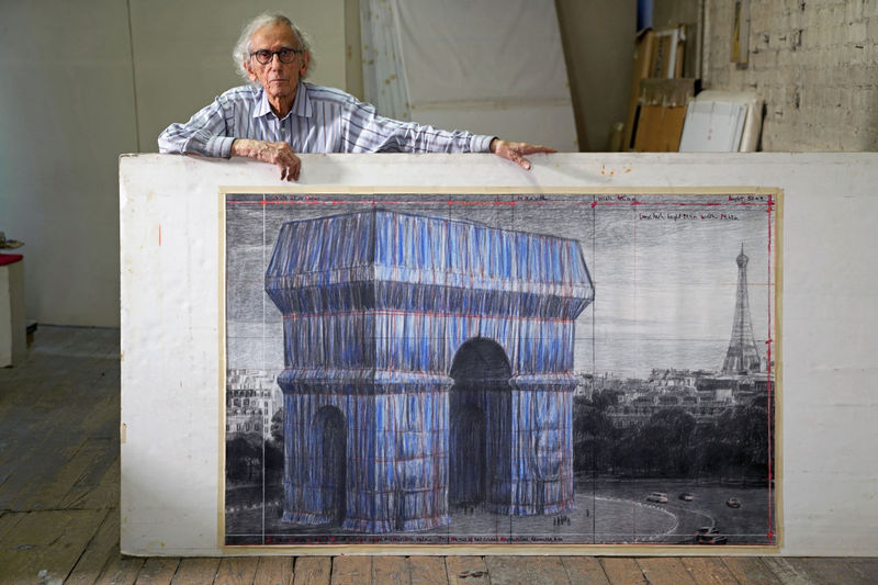 Christo in his studio with a preparatory drawing for L'Arc de Triomphe, Wrapped in 2019. Photo: Wolfgang Volz
