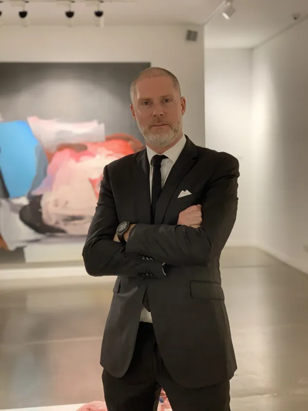 Image shows Founder Jean David Malat standing in his Mayfair gallery