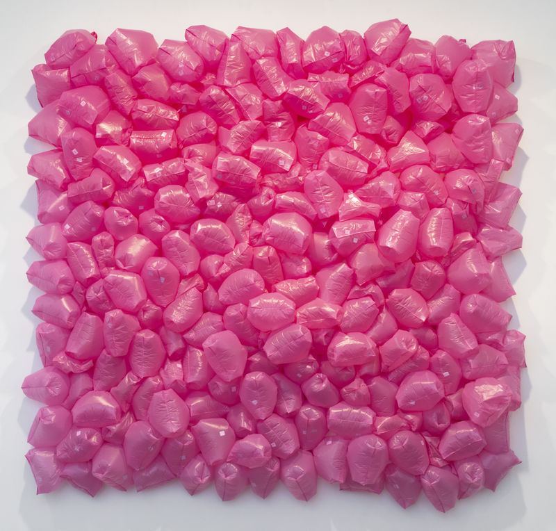 Pink plastic bags filled with air composed into a square composition 