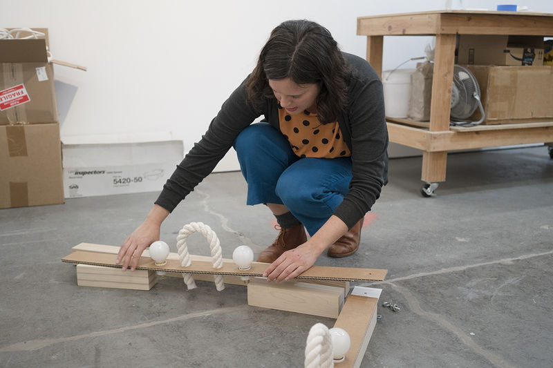 Hemenway with a cardboard mock-up of a commissioned piece for a hotel in Healdsburg. (Graham Holoch / KQED)