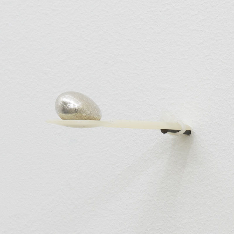 SANNA HELENA BERGER, Ohne Ohne Titel, nail, plastic cable tie, biodegradable spoon 9.5 cm x 2.1 cm, roasted almond with silver coloured sugar coating 2.5 x 1.5 x 1 cm