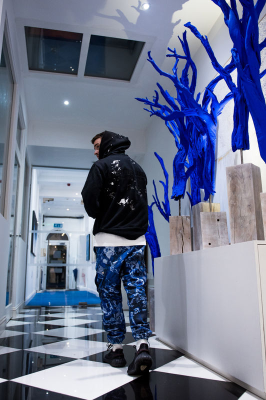 Artist Will Solomon with his blue tree sculptures