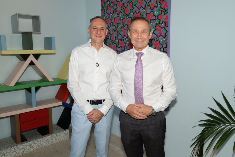 Photograph of OFFMARKET Gallery Director Olivier David standing beside the Premier of Western Australia, Roger Cook, at the gallery’s official opening in Claremont. The image shows both smiling in front of a Memphis-inspired artwork and shelving unit, mar