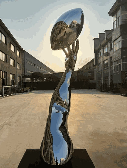 “Opportunity (reflection)” by Hank Willis Thomas. Its reflective surface resembles the Vince Lombardi Trophy given to the winning Super Bowl team.Credit...Hank Willis Thomas Studio