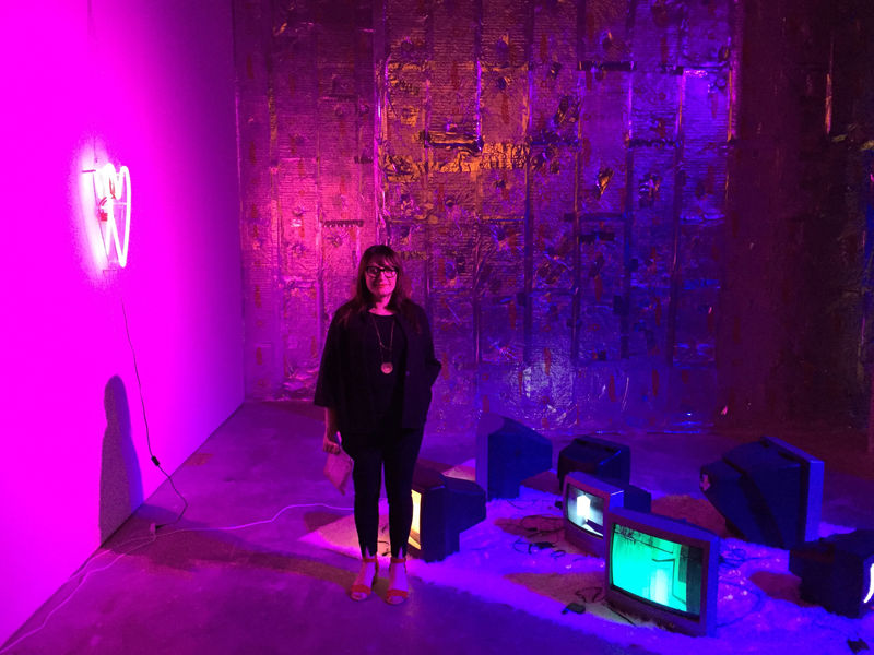 joy tirade, with her work, Fictional Desires, video, and neon installation, in the exhibition at Mint Museum part of MAINFRAME, 2018