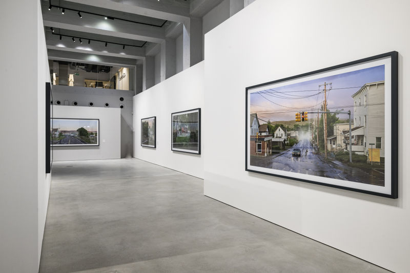 Gregory Crewdson exhibition installation view with large framed suburban photographs on white gallery walls