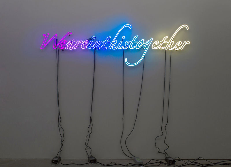 An image containing a neon sculpture by Tavares Strachan that reads "We are in this together."