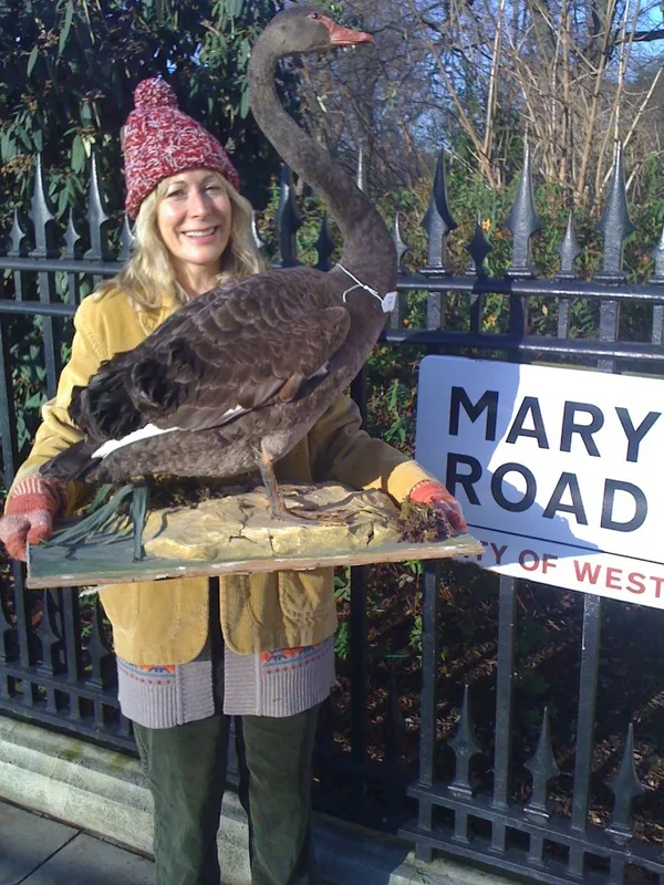 Rebecca Hossack carrying a swan for Derren Brown