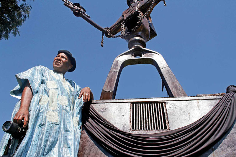 DIEPKLOOF, SOUTH AFRICA – JANUARY 27: Professor Pitika Ntuli stands by the statue of the ‘Silverton Three’ on January 27, 2013 in Diepkloof, South Africa. A monument celebrating the lives of three struggle heroes; Madela Makhubo, Steven Mafoko and Wilfred Madela, was unveiled over the weekend. In 1980, these men, referred to as the ‘Silverton Three’, embarked on a mission to attack a petrol depot in Pretoria but were shot by the police before they could get reach their destination. (Photo by Gallo Images / Sowetan / Bafana Mahlangu)