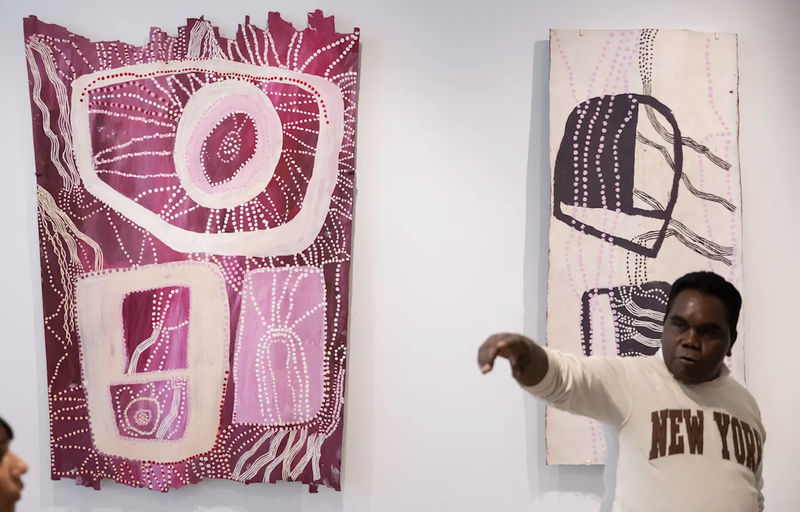 Yinimala Gumana from Yirrkala, north-east Arnhem Land, with the two works by Yolŋu artist Nonggirrnga Marawili.