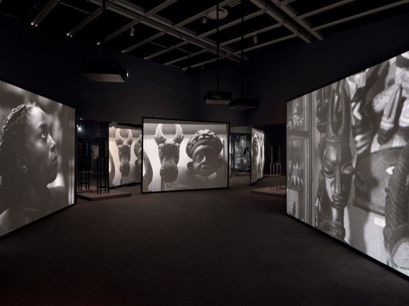 Installation view of Whitney Biennial 2024: Even Better Than the Real Thing (Whitney Museum of American Art, New York, 20 March–11 August 2024). Isaac Julien, Once Again… (Statues Never Die), 2022; in back: Matthew Angelo Harrison, Dark Silhouette: Borrowed Inlets – Dogon, 2018; Matthew Angelo Harrison, Dark Silhouette: Enduring Bond, 2019. Photograph by Ron Amstutz