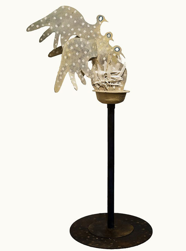 Stylised stone sculpture of three bird silhouettes atop a thin metal pedestal.