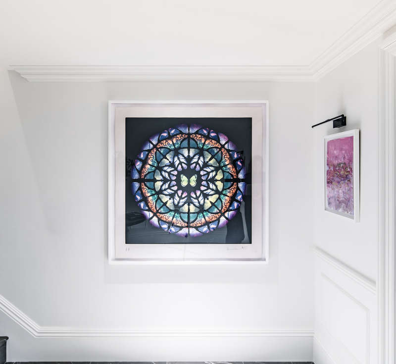 List Image: Damien Hirst contemporary art prints, UP from Sanctum, hang on a white wall, as the owner contemplates the art of collecting art.