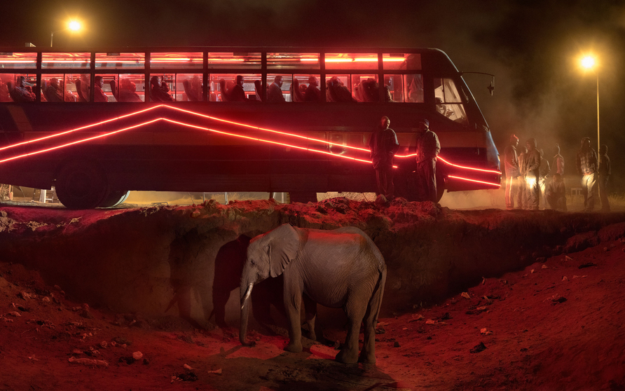 <span class="artist"><strong>Nick Brandt</strong></span>, <span class="title"><em>Bus Station with Elephant and Red Bus</em>, 2018</span>
