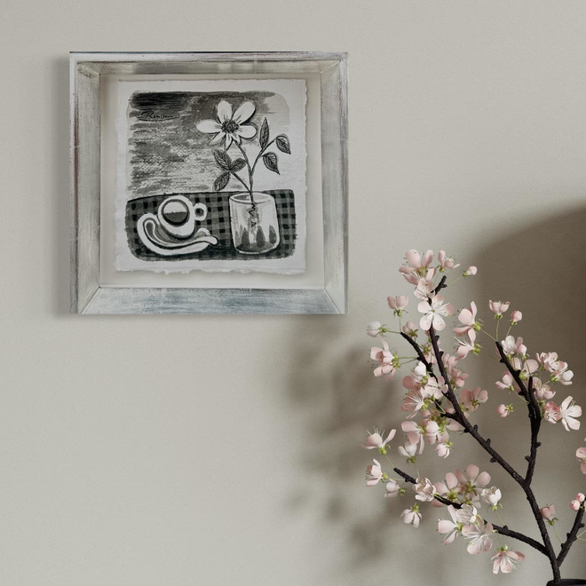 Still life with coffee cup and flower in a glass