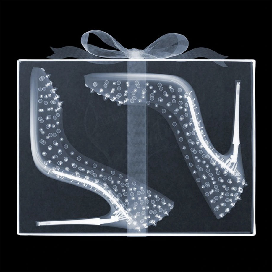 Nick Veasey X-ray photograph of Christina Louboutin heels in a box with a bow around it
