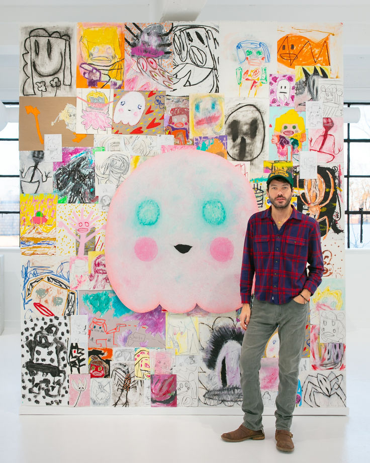 Artist Adam Hander with "Grandma Ghost" artwork on art wall with sketches and drawings
