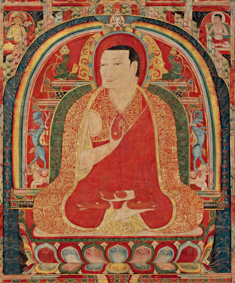 The Abbot is depicted seated in the lotus position with his hands in abhaya mudra, signifying protection and overcoming fear.  